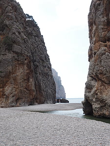 two rock cliffs on body of water thumbnail