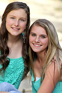 two girls wearing green sleeveless tops thumbnail