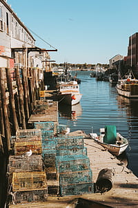 assorted-color bird cage lot on wooden dock beside body of water thumbnail