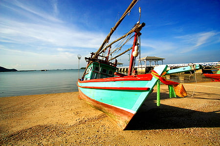 boat docked on seashore thumbnail