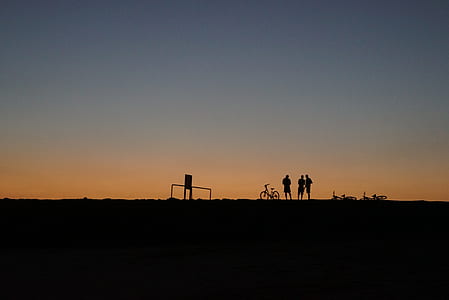 silhouette of three persons standing thumbnail