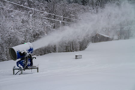 blue machine producing fog on top of snow thumbnail