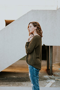 woman standing near white concrete stairway thumbnail