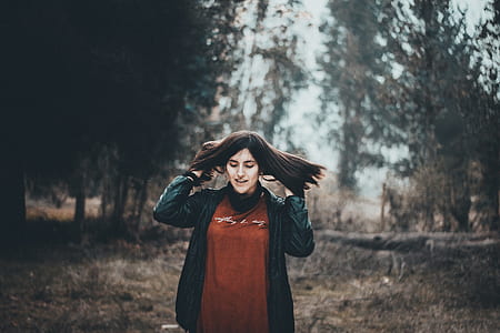 woman standing near trees thumbnail