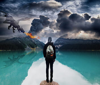 black wearing pullover hoodie in front blue ocean water near gray mountain under gray cloudy sky and dragon thumbnail