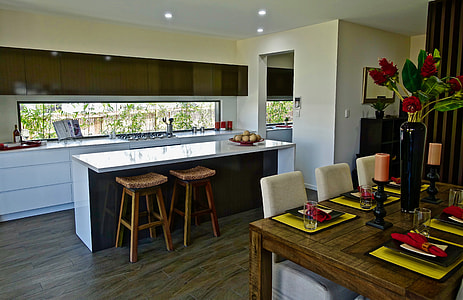 rectangular brown wooden dining table near on white kitchen island thumbnail