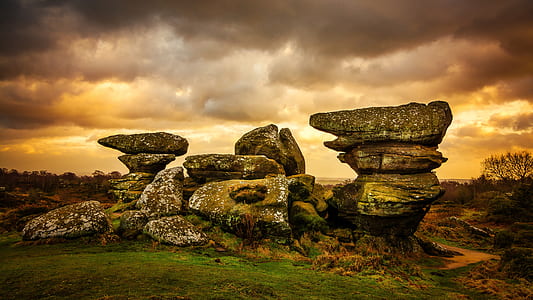 gray rock formation under cloudy skies thumbnail