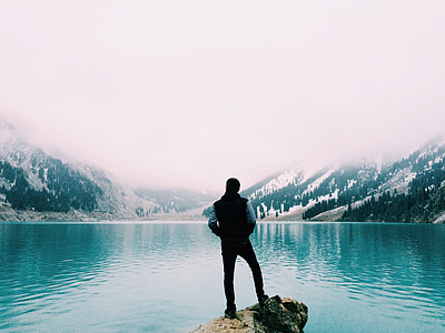man standing near large body of water thumbnail