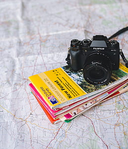 black Fujifilm bridge camera on top of assorted books thumbnail