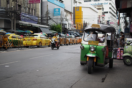green auto rickshaw parked beside road thumbnail