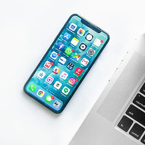 silver iPhone X beside MacBook thumbnail