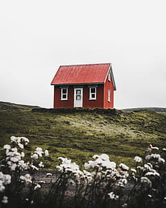 low-angle photography of red and white house under gray sky thumbnail