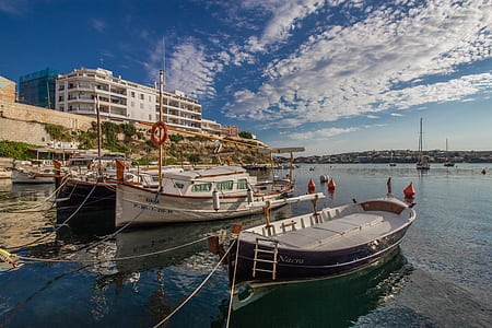 two boats tied on dock at daytime thumbnail