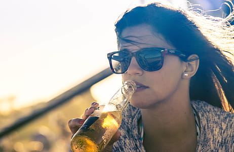 Woman Drinking Beverage on Bottle thumbnail
