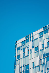photo of white and blue high-rise building thumbnail