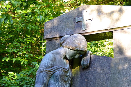 woman leaning concrete wall statue at daytime thumbnail