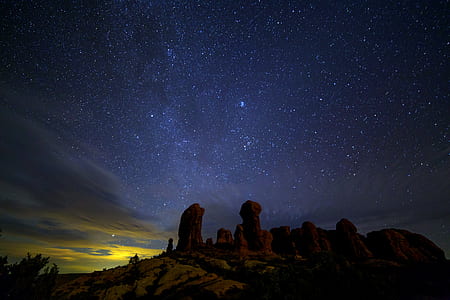 silhouette of rock formation at night time thumbnail