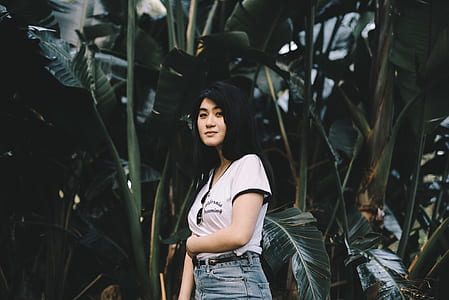 woman standing beside banana trees thumbnail
