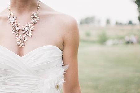 woman wears white sweetheart wedding dress on open field during daytime thumbnail