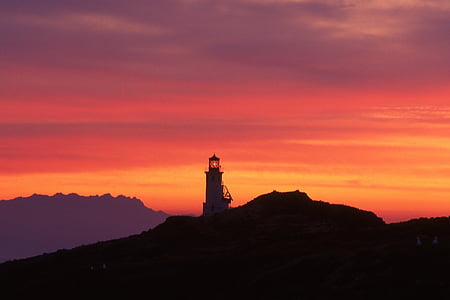white lighthouse photo during sunset thumbnail