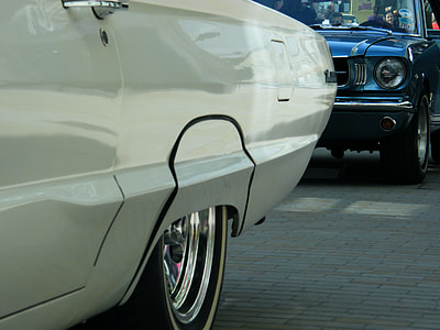 classic blue car behind white car thumbnail