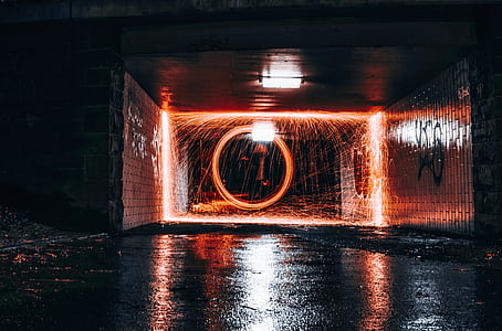steelwool photography of man inside the tunnel thumbnail