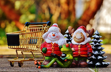 selective focus photography of Santa Claus and Rudolph figurines thumbnail