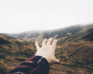 person reaching the mountains thumbnail