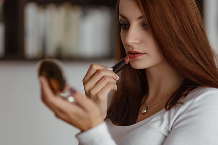 Young beautiful woman doing her make up thumbnail