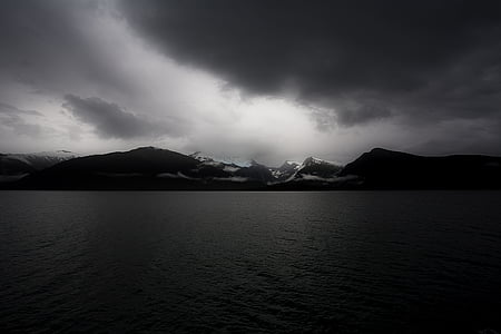 landscape photograph of body of water near mountain thumbnail