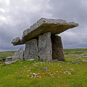 gray rock formation surrounded with grass thumbnail