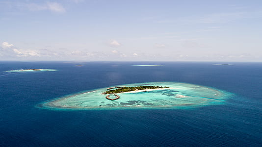 aerial view of island under blue sky during daytime thumbnail