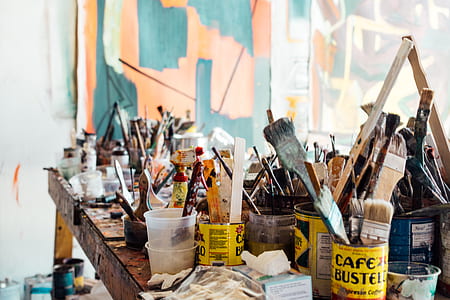 assorted-color paint brush on wooden table thumbnail