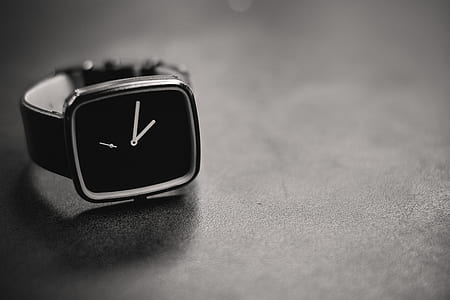 shallow focus photography of black analog watch on gray surface thumbnail