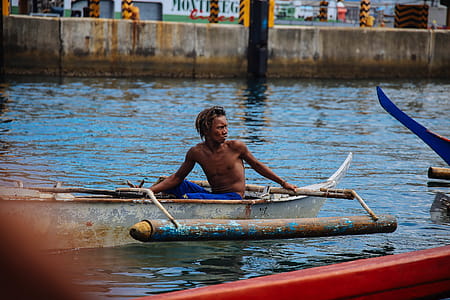 Man in Blue Shorts on Gray Boat thumbnail