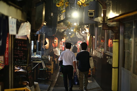 two person walking near stores thumbnail