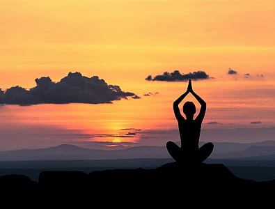 silhouette of person taking yoga pose thumbnail
