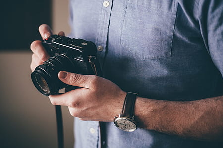 man holding black dslr camera thumbnail