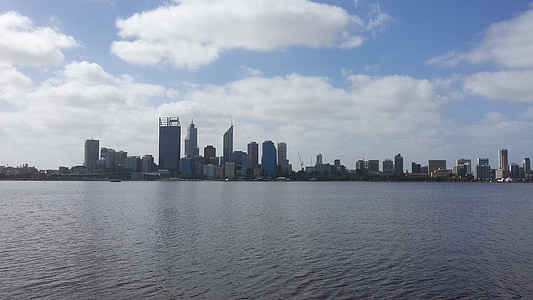concrete buildings beside body of water at daytime thumbnail