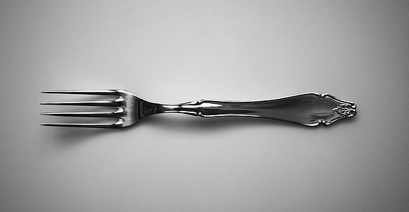 gray stainless steel fork on white surface thumbnail