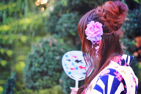 selective photo of brown and pink haired woman in black,white and blue floral dress thumbnail
