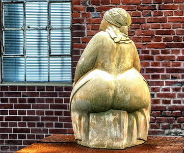sitting woman statuette near windowpane thumbnail
