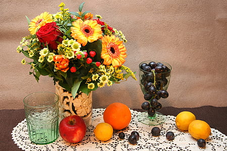 assorted flowers and fruits on table thumbnail