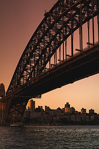 cantilever bridge over boat on body of water thumbnail