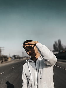 time lapse photography of man standing on road thumbnail