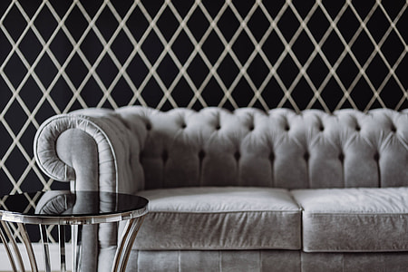 Elegant grey sofa with a laptop, an iPhone and a magazine thumbnail