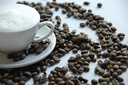 white ceramic cup with saucer and coffee beans thumbnail