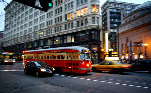 vehicles on road surrounded by buildings during daytime thumbnail