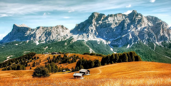 landscape photo of brown field and mountains during dautime thumbnail