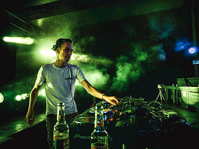DJ performing on foggy stage thumbnail